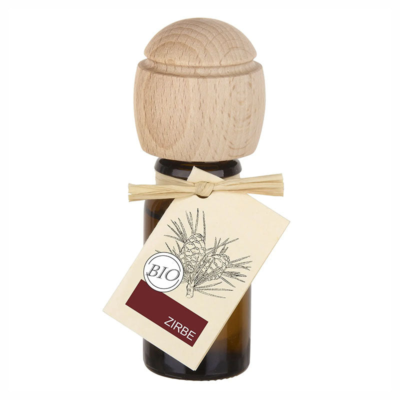 Braunes Glasfläschchen mit Holz-Duftkopf und Etikett Zirbe.