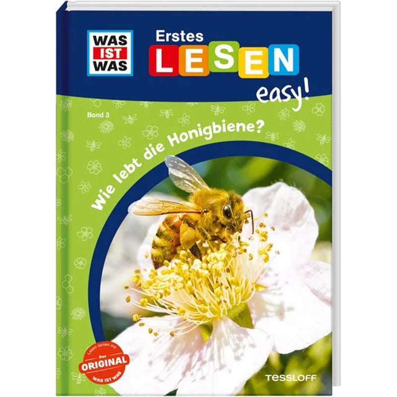 Buchcover von „Wie lebt die Honigbiene?“ aus der Reihe „WAS IST WAS – Erstes Lesen easy!“. Auf dem Titel ist eine Honigbiene zu sehen, die Nektar aus einer weißen Blüte saugt.