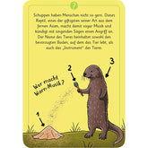 Spielkarte mit Rätsel „Wer macht Warn-Musik?“ und Illustration eines Erdhügels, eines Tieres mit Rassel und einer Ratte als Hinweisbilder.