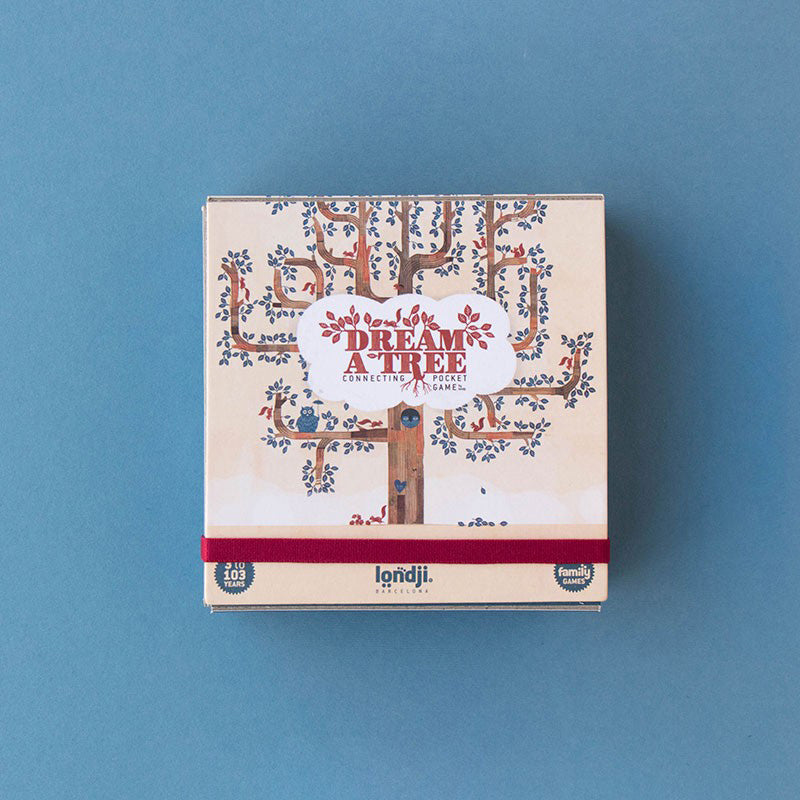 Verpackung des Spiels „Dream a Tree“ von Londji, auf blauem Hintergrund liegend.