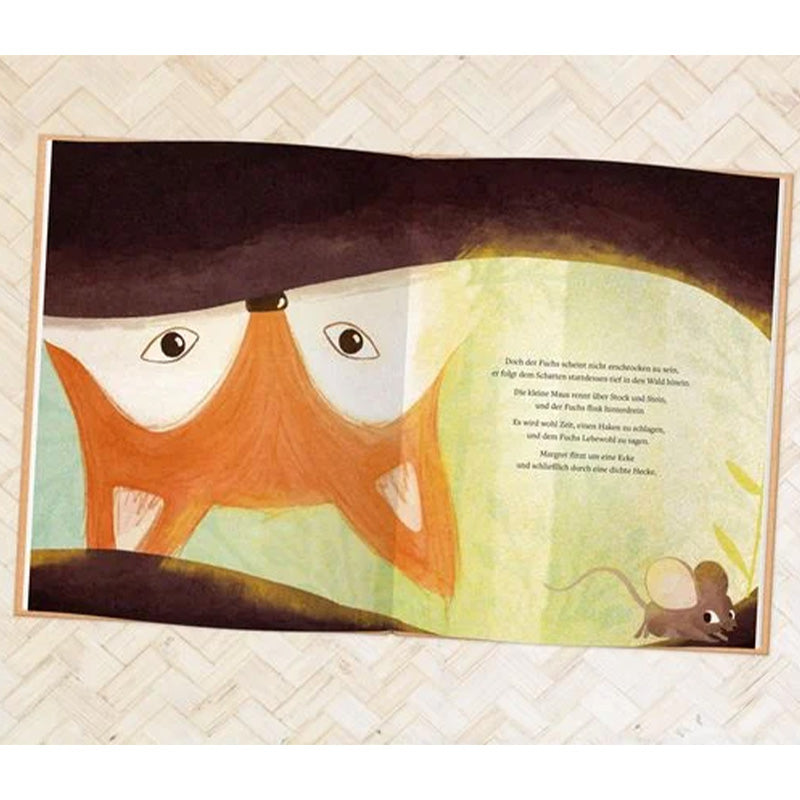 Buchseite: Der Fuchs und die Maus begegnen sich im Wald, der Fuchs schaut vorsichtig, während die Maus neben ihm steht.
