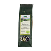 Packung Zaubertee Bio-Kräuterteemischung von Almenland Kräuter, grüne Verpackung mit Sichtfenster.