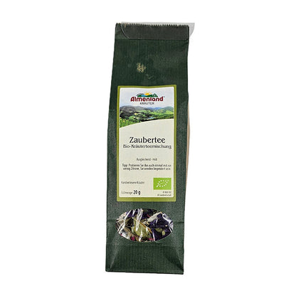 Packung Zaubertee Bio-Kräuterteemischung von Almenland Kräuter, grüne Verpackung mit Sichtfenster.