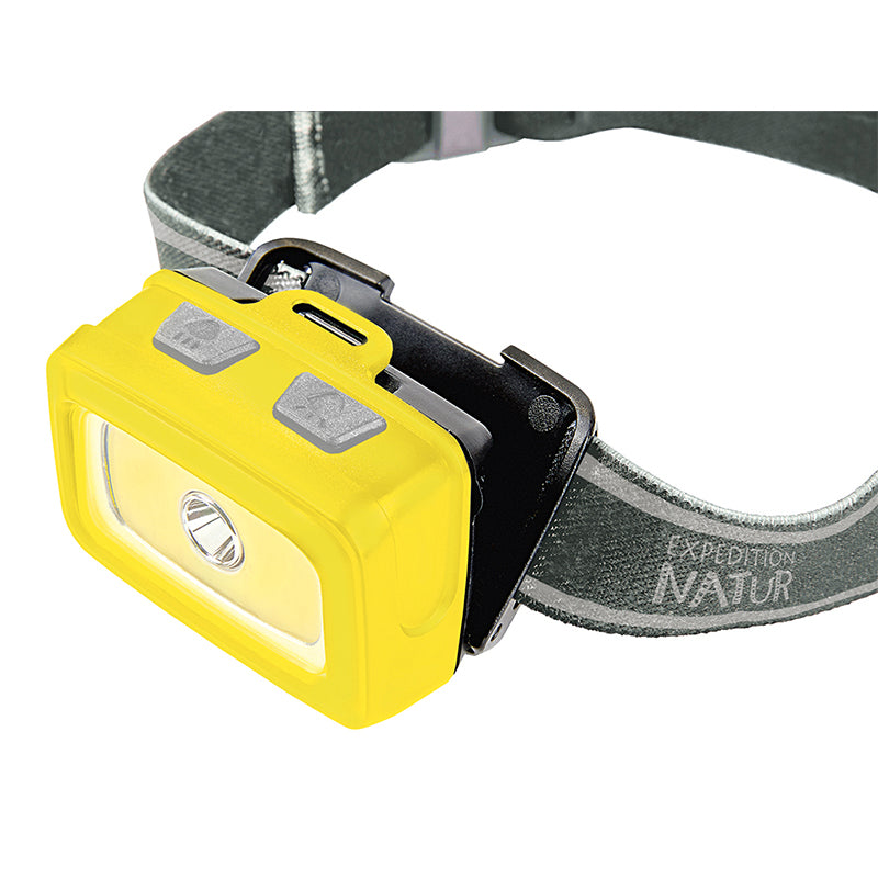 Nahaufnahme der gelben LED-Stirnlampe am Stirnband mit zwei grauen Knöpfen oben.