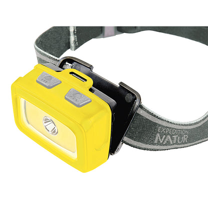 Nahaufnahme der gelben LED-Stirnlampe am Stirnband mit zwei grauen Knöpfen oben.