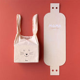 Stofftasche mit Hasengesicht neben geöffneter Verpackungskarte mit der Aufschrift „MaMA My First 7 Puzzles“.