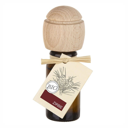 Braunes Glasfläschchen mit Holz-Duftkopf und Etikett Zirbe.