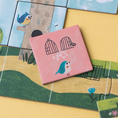 Rosa Spielplättchen mit Vogel-Illustration und Käfigsymbolen.