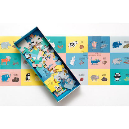 Offene Puzzlebox mit sichtbaren Teilen und einem teilweise zusammengesetzten Puzzle mit Tierzeichnungen und Kacke-Darstellungen.