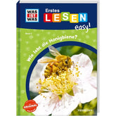 Buchcover von „Wie lebt die Honigbiene?“ aus der Reihe „WAS IST WAS – Erstes Lesen easy!“. Auf dem Titel ist eine Honigbiene zu sehen, die Nektar aus einer weißen Blüte saugt.