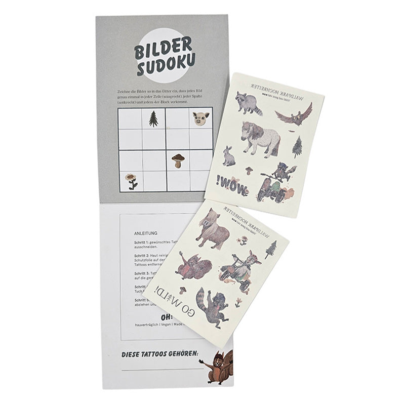 Offene Mappe mit zwei Bögen Waldpark Hochreiter-Tattoos und einem gezeichneten Bilder-Sudoku-Spiel.