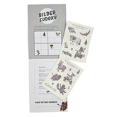 Offene Mappe mit zwei Bögen Waldpark Hochreiter-Tattoos und einem gezeichneten Bilder-Sudoku-Spiel.