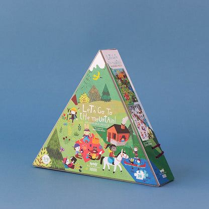Pyramidenförmige Puzzleverpackung mit der Aufschrift „Let’s Go to the Mountain!“ und farbenfroher Berglandschaft mit Tieren und Kindern beim Spielen.