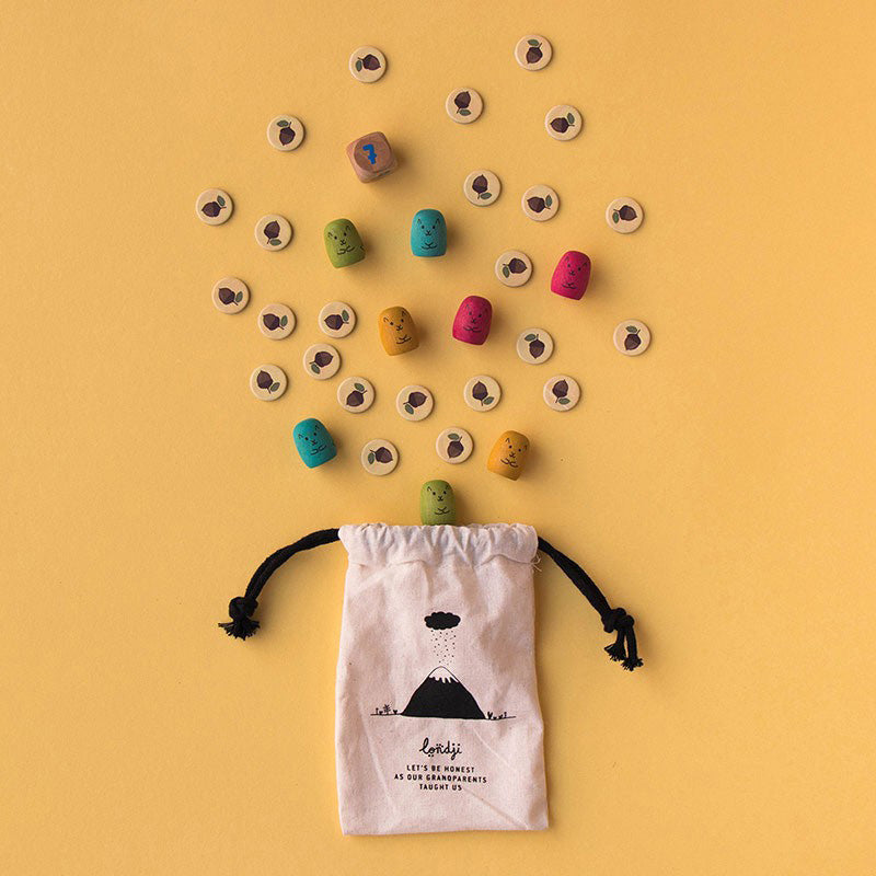 Stoffbeutel mit Spielsteinen und Eichhörnchen-Figuren, die herauspurzeln